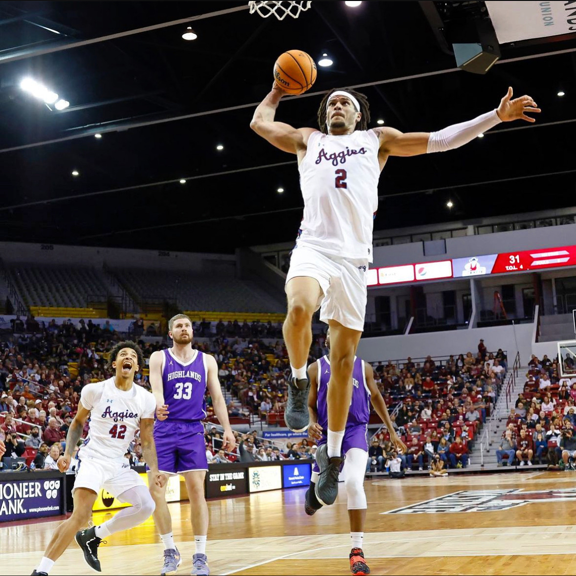 Issa Muhammad finishing above the rim for New Mexico State